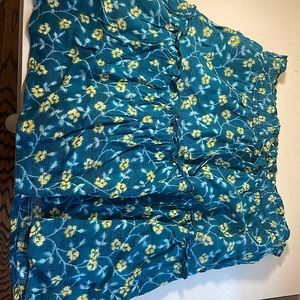 This is a very floral skirt with yellow flowers and a blueish, greenish color